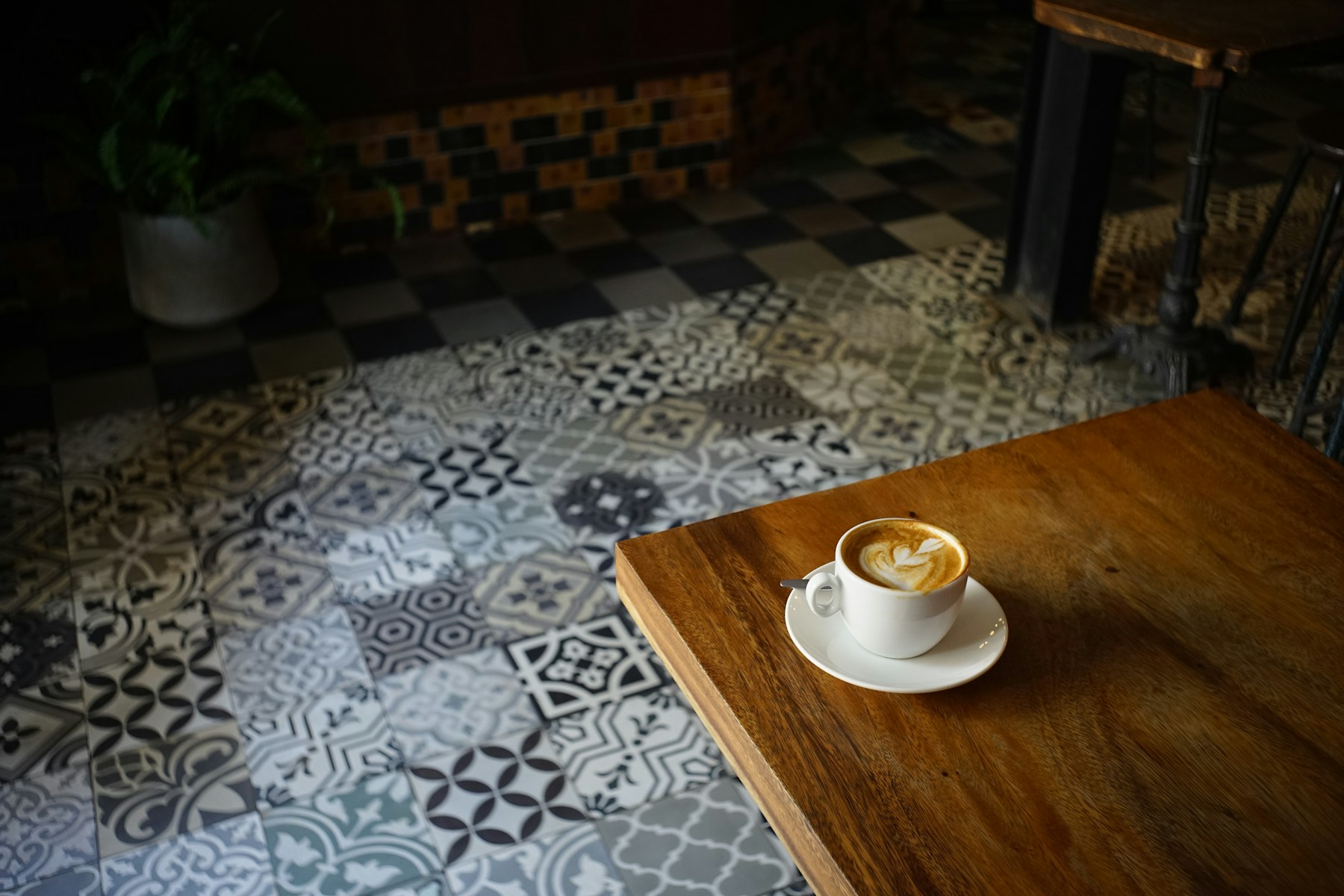 Cappuccino on a wooden cafe table, used in a coffee shop website concept
